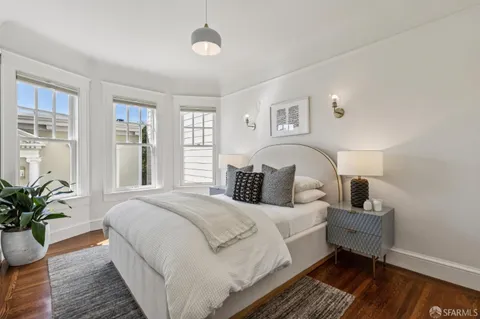 a bathroom with a tub a sink and mirror
