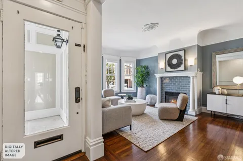 a living room with furniture two windows and a fireplace