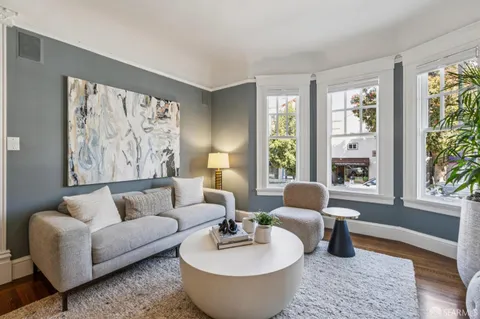a view of a living room and hardwood floor