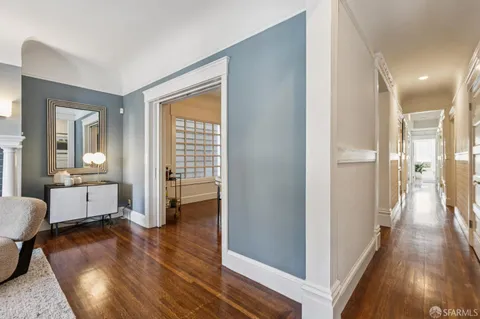 a dining room with furniture and wooden floor
