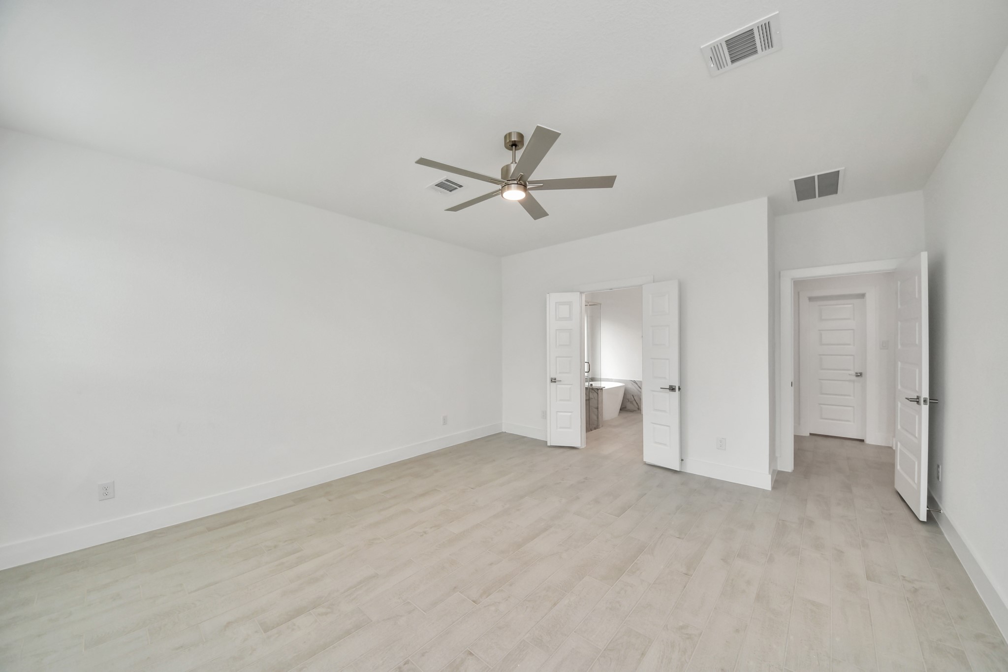 3106 Native Spg Drive Spring, TX 77373 - Photo 25 of 47 Escape and relax in the exquisite primary suite, a haven to unwind after a long day. The spacious room, located on first floor, boasts plush carpeting, soothing paint tones, high ceilings, and expansive windows adorned with privacy blinds.