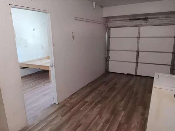 a view of a room with wooden floor