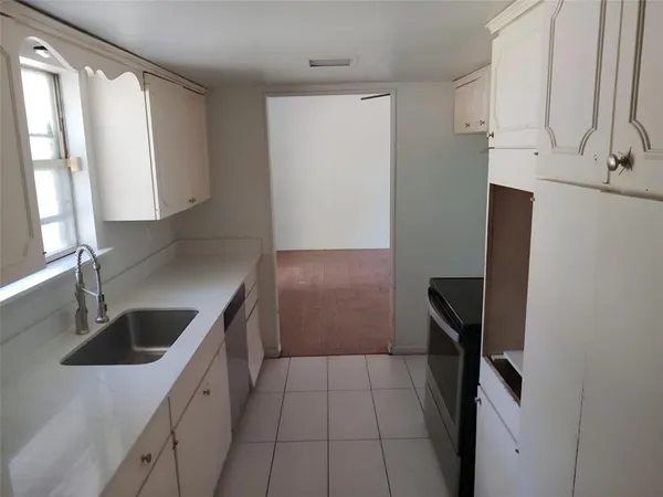 a kitchen with a sink and a refrigerator