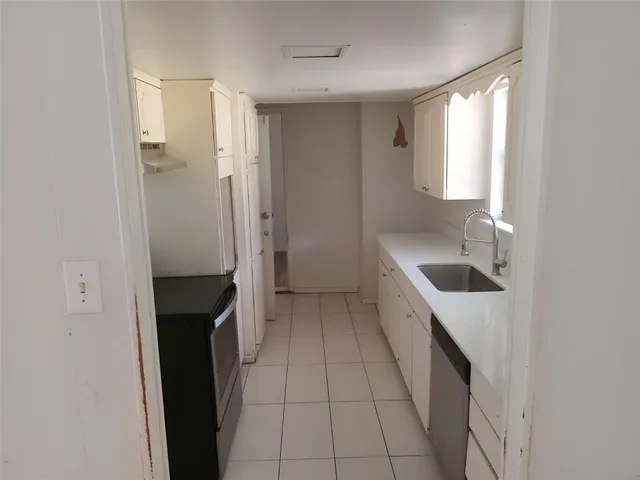 a kitchen with a refrigerator and a sink