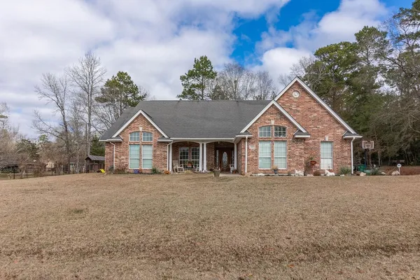 a view of a house with wooden fence