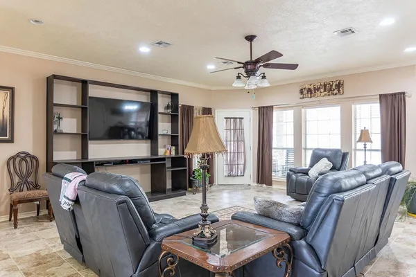 a living room with furniture and a large window