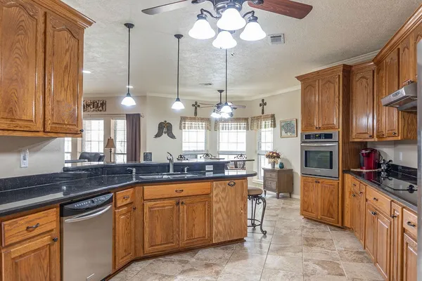 a kitchen with stainless steel appliances granite countertop a sink and cabinets