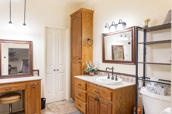 a bathroom with a sink vanity granite and a mirror