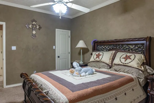 a bedroom with a bed and a chandelier