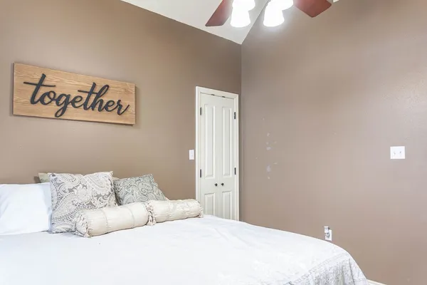 a bedroom with a bed and a night stand