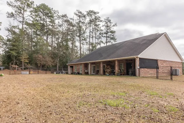a view of a house with a large tree in front of it