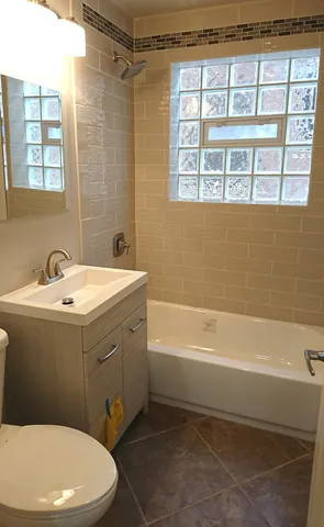 a bathroom with a sink toilet and bathtub