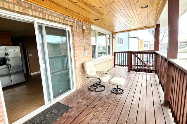 a view of a balcony with wooden floor