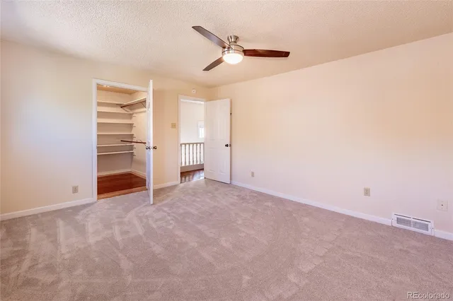 a view of an empty room with a fan