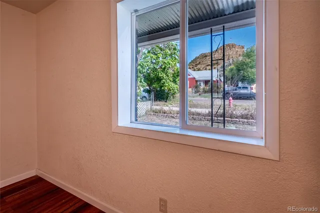 a view of a balcony with a floor to ceiling window and wooden floor