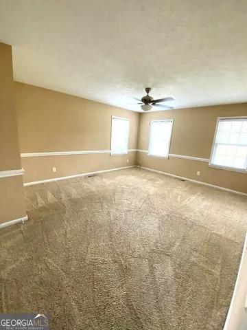 a bathroom with a granite countertop sink toilet and mirror