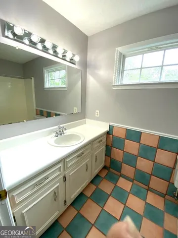 a bathroom with a black and white checkered floor