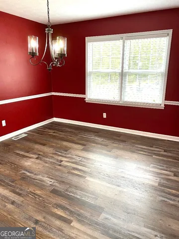 a view of a room with wooden floor and windows