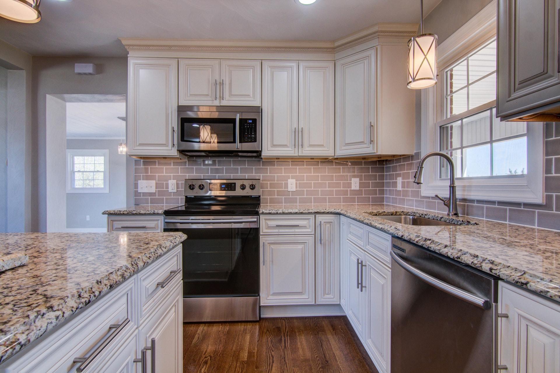 452 Lucy Wade Road Rocky Mount, VA 24151 - Photo 13 of 74 a kitchen with stainless steel appliances granite countertop a sink dishwasher stove and microwave with wooden floor