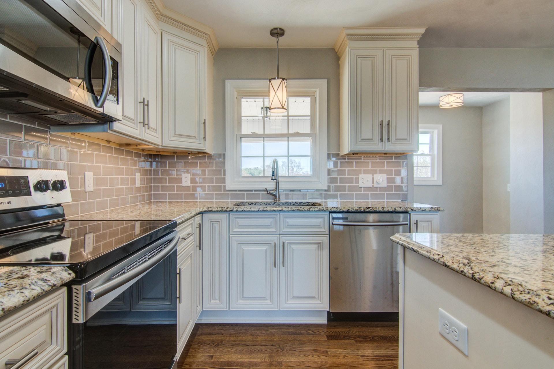 452 Lucy Wade Road Rocky Mount, VA 24151 - Photo 14 of 74 a kitchen with stainless steel appliances granite countertop a sink stove and cabinets