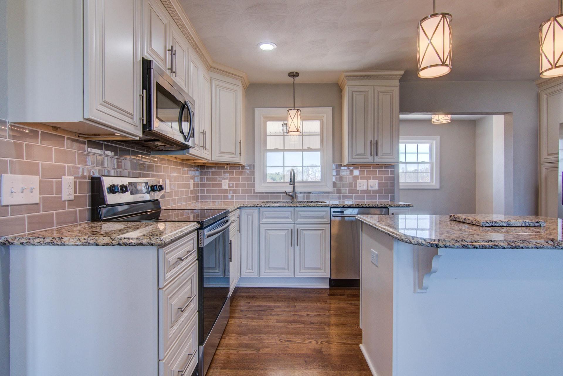 452 Lucy Wade Road Rocky Mount, VA 24151 - Photo 15 of 74 a kitchen with stainless steel appliances granite countertop a sink a stove top oven a counter space and cabinets
