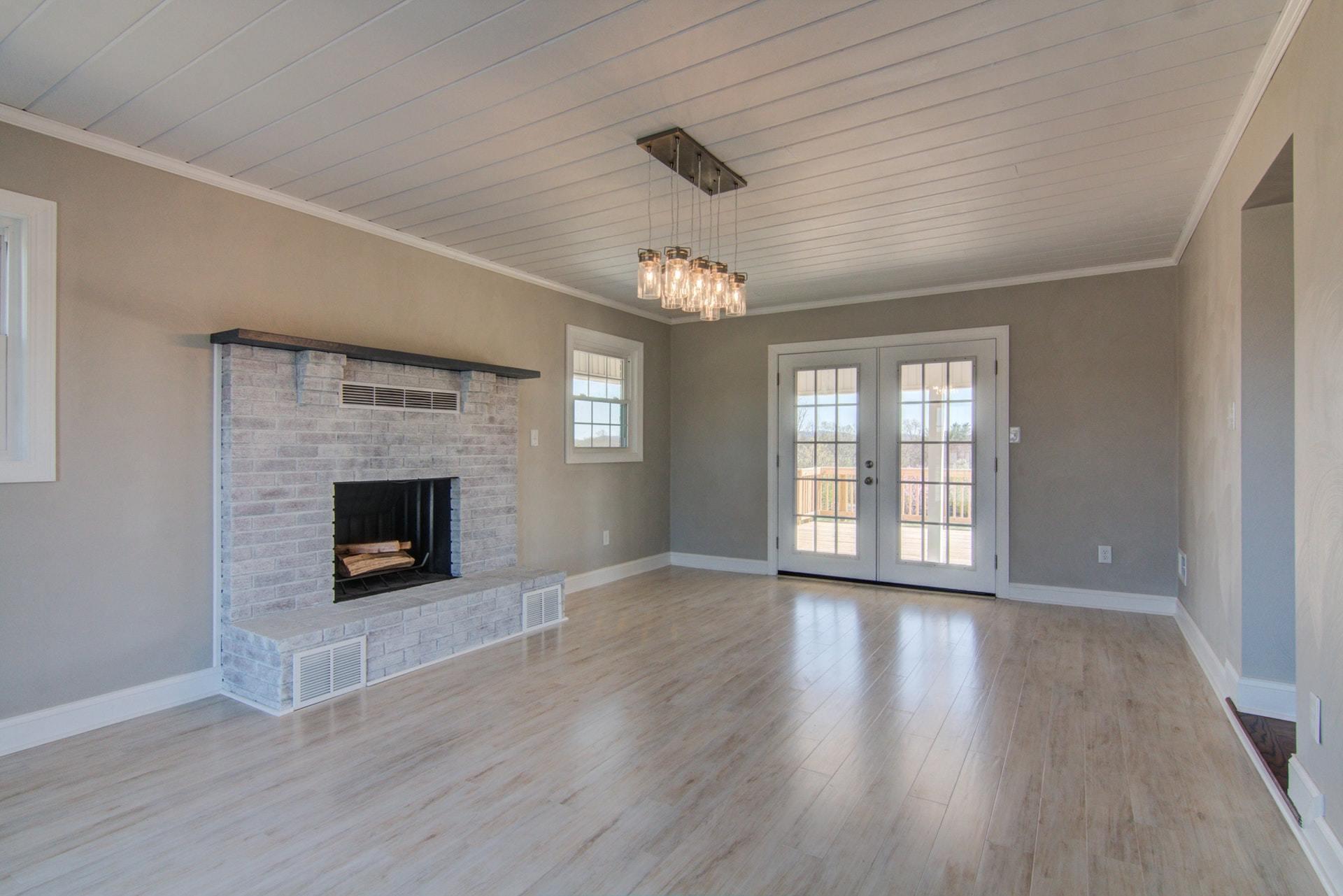 452 Lucy Wade Road Rocky Mount, VA 24151 - Photo 18 of 74 a view of an empty room with wooden floor fireplace and a window