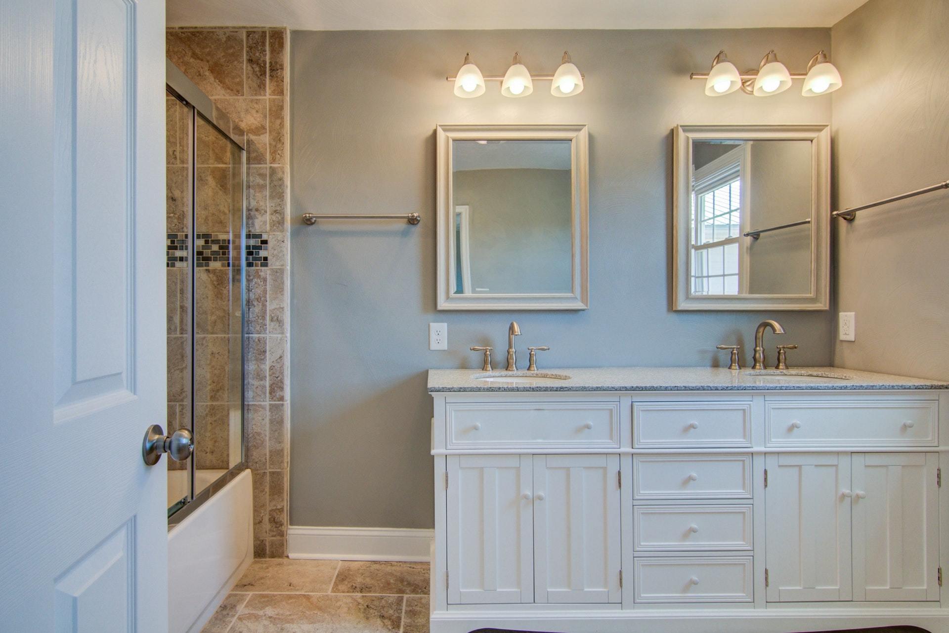 452 Lucy Wade Road Rocky Mount, VA 24151 - Photo 21 of 74 a bathroom with a double vanity sink a mirror and a bathtub