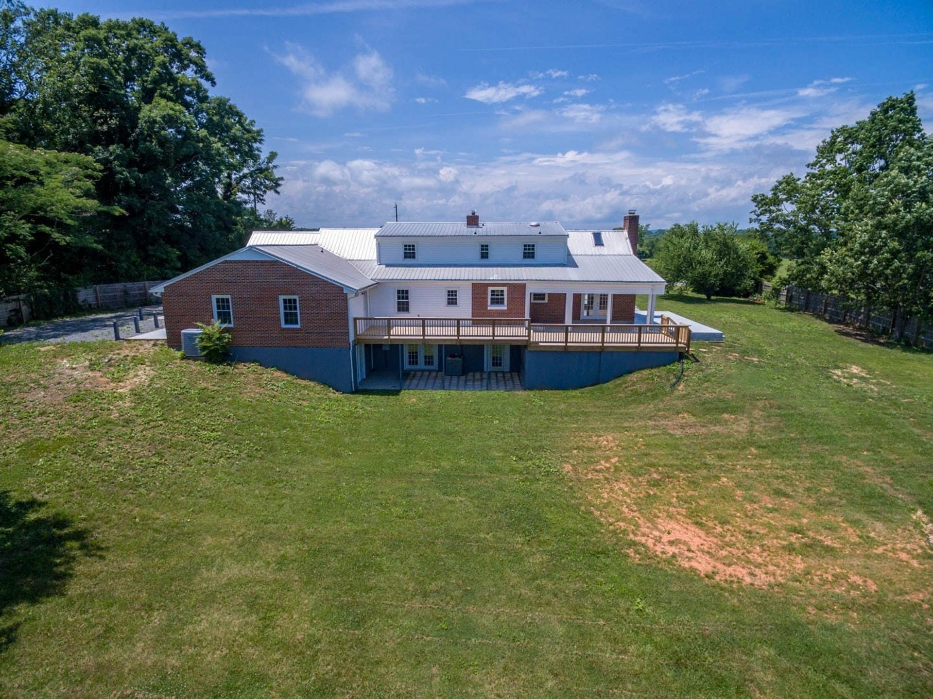 452 Lucy Wade Road Rocky Mount, VA 24151 - Photo 4 of 74 a aerial view of a house with a big yard and large trees