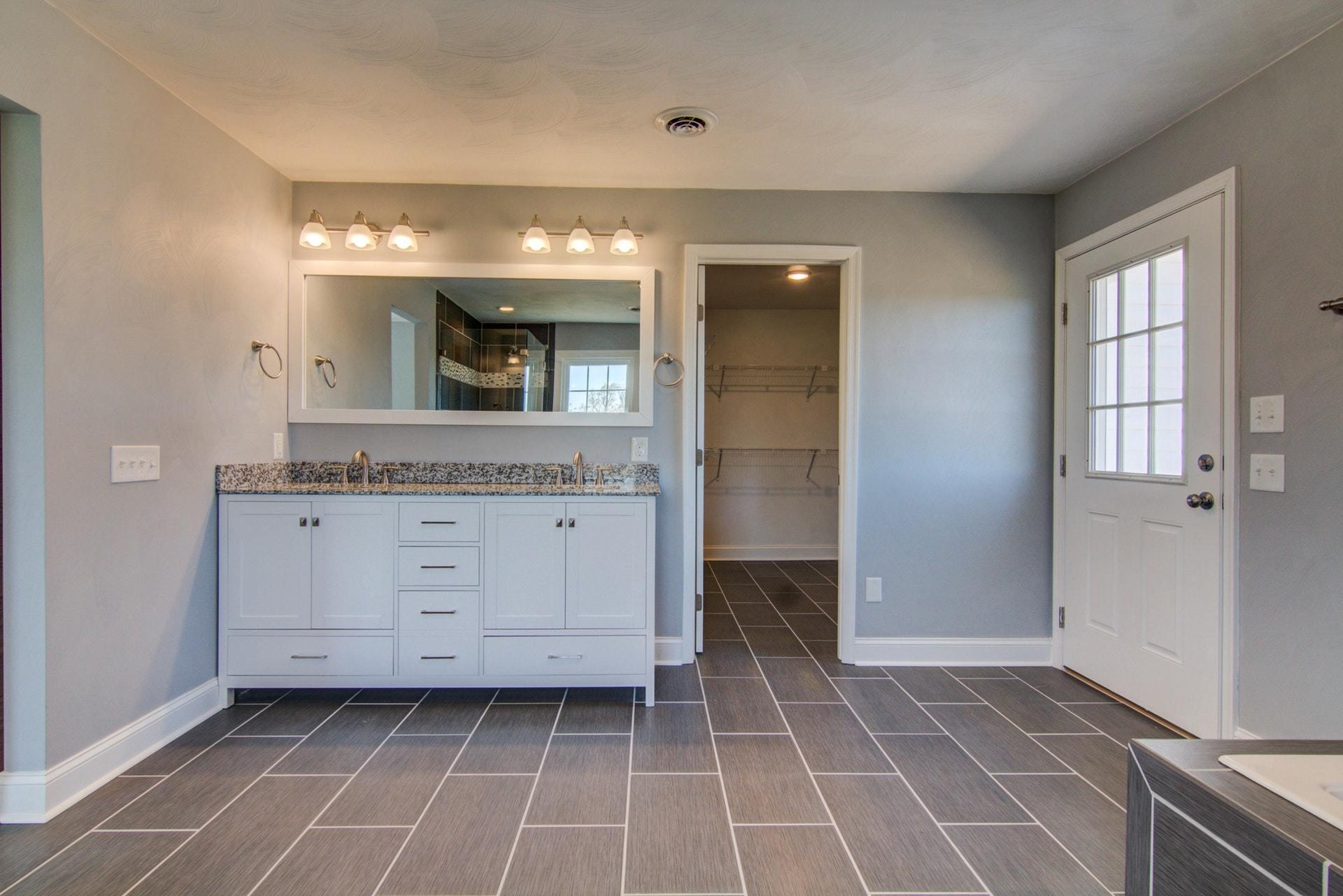 452 Lucy Wade Road Rocky Mount, VA 24151 - Photo 35 of 74 a bathroom with a granite countertop sink a mirror and a shower