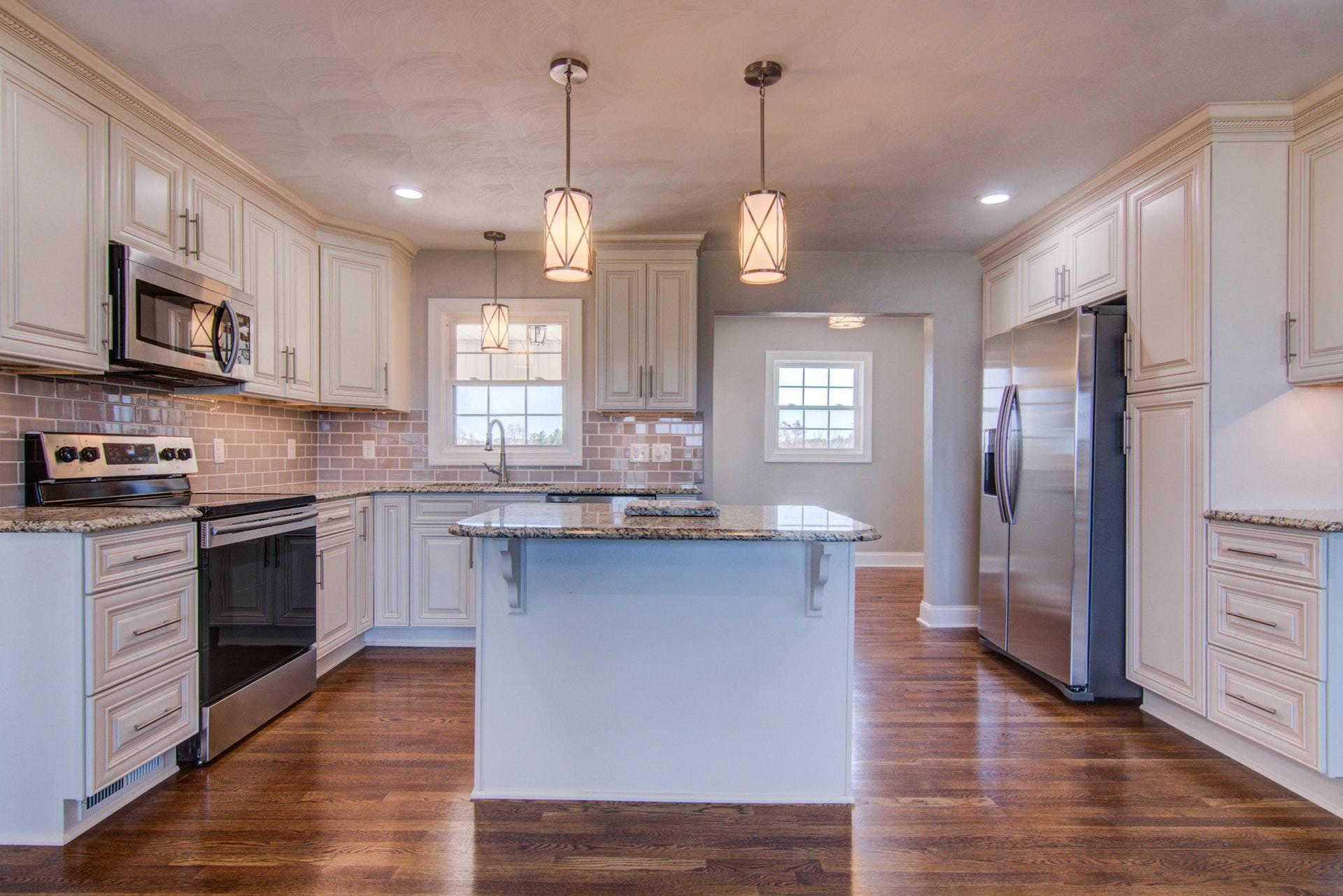 452 Lucy Wade Road Rocky Mount, VA 24151 - Photo 10 of 74 a open kitchen with stainless steel appliances granite countertop a stove a sink dishwasher a refrigerator and a fireplace with wooden floor