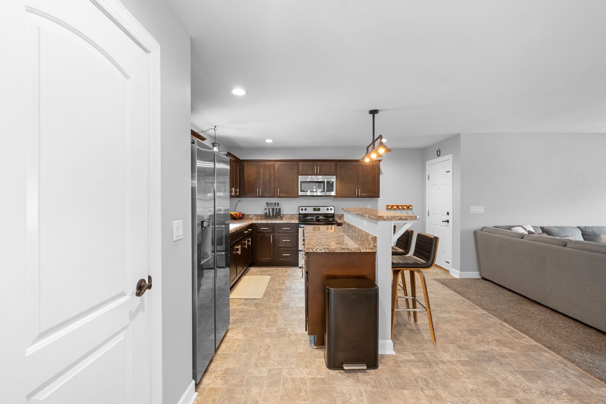 7401 Burks Hollow Road Christiana, TN 37037 - Photo 19 of 56 a kitchen view with stainless steel appliances kitchen island granite countertop a sink and a refrigerator