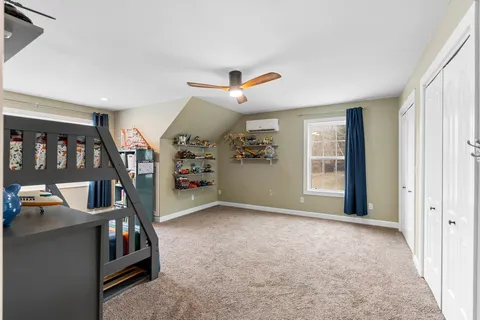 a bedroom with furniture and a large window