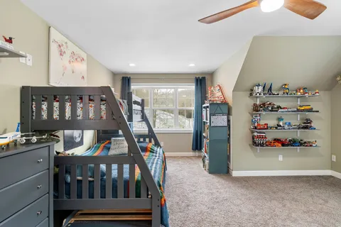 a bedroom with furniture and a book shelf