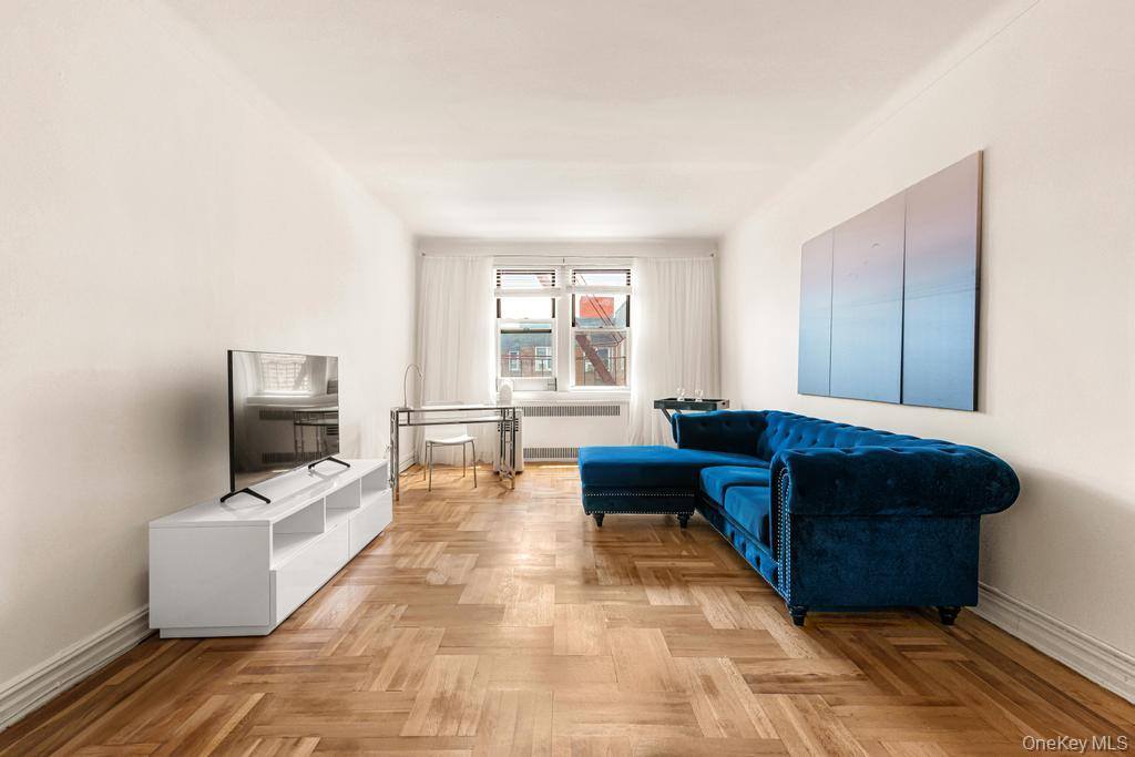 100-10 67th Road, Unit 6L Queens, NY 11375 - Photo 14 of 26 a living room with furniture and a flat screen tv