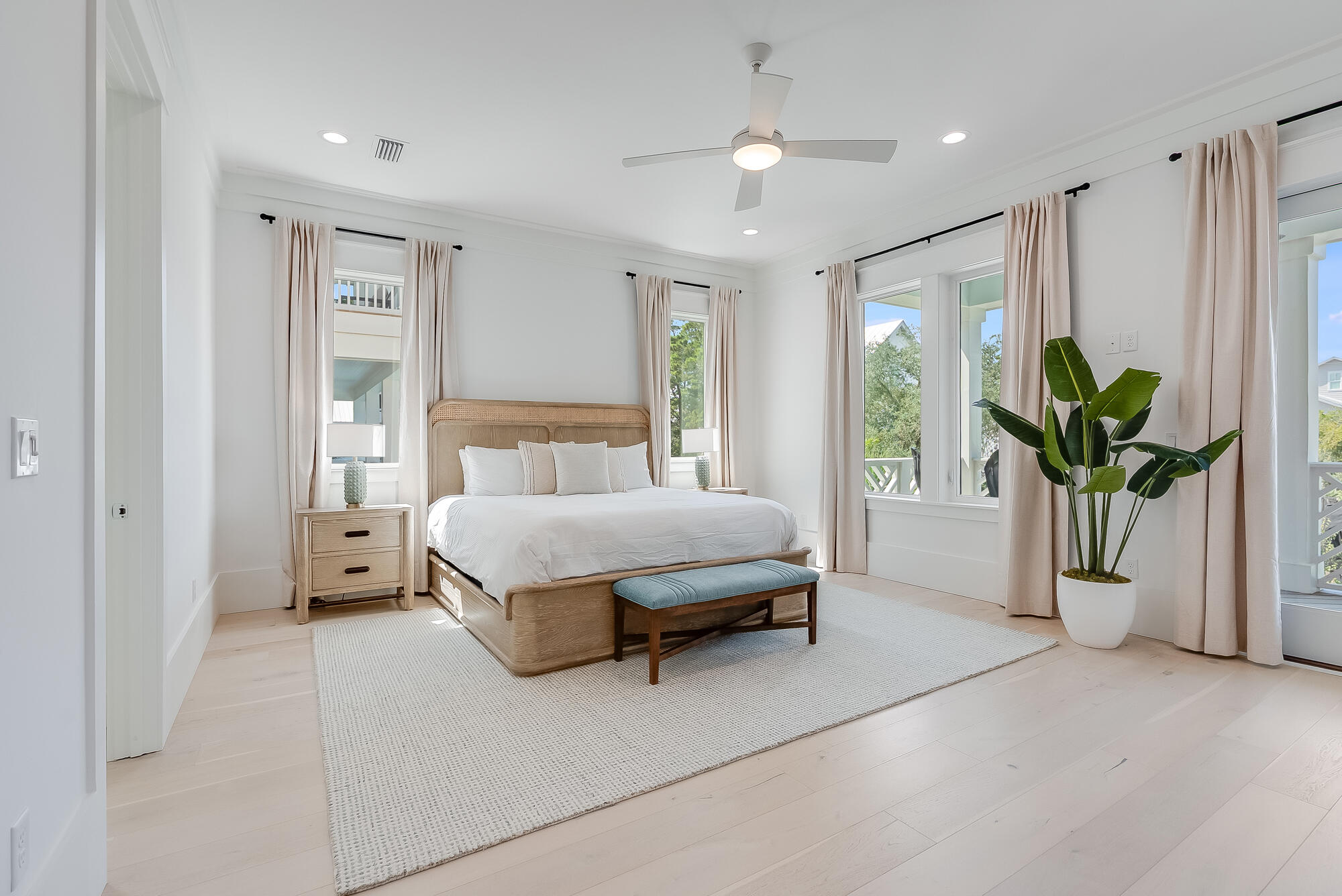 212 South Gulf Drive Santa Rosa Beach, FL 32459 - Photo 22 of 68 a spacious bedroom with a large bed and a chandelier