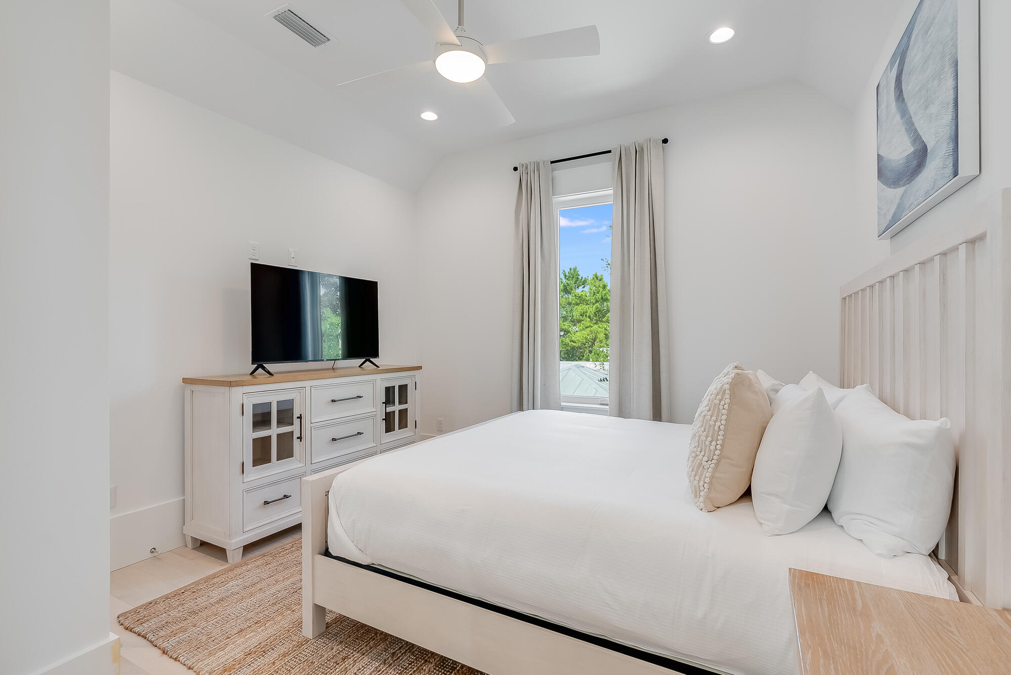 212 South Gulf Drive Santa Rosa Beach, FL 32459 - Photo 49 of 68 a bedroom with a large bed and a flat screen tv