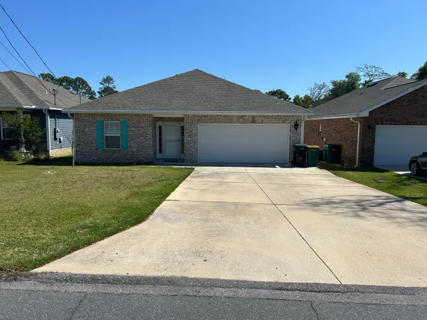a front view of house with yard and trees