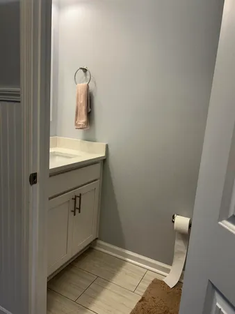 a bathroom with a sink a mirror and vanity