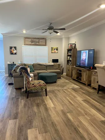 a living room with furniture and a flat screen tv
