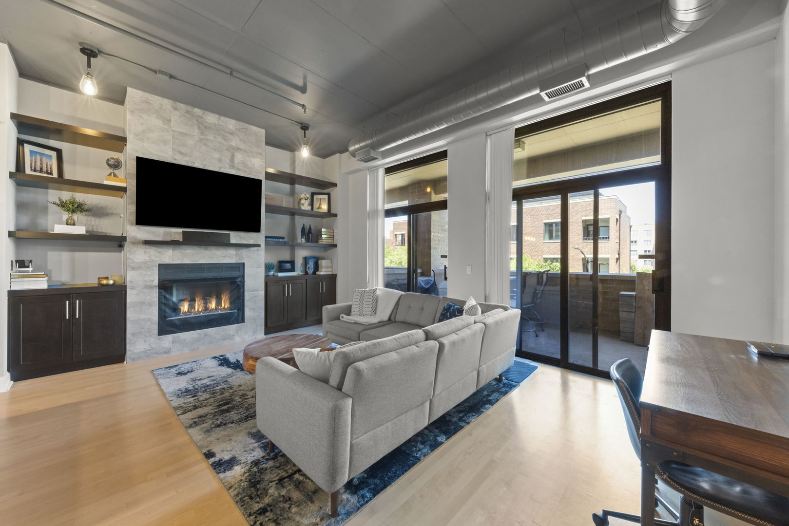 1301 West Madison Street, Unit 305 Chicago, IL 60607 - Photo 11 of 22 a living room with furniture fireplace and flat screen tv