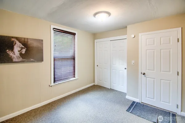 an empty room with windows and closet
