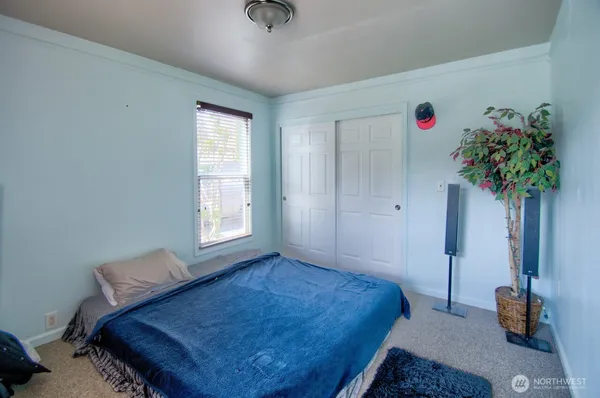 a bedroom with a bed and a window