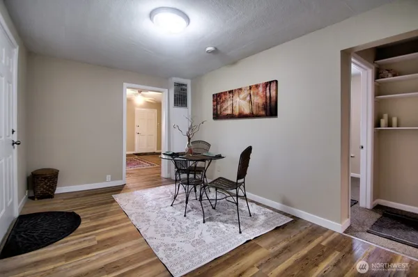 a view of a dining room with furniture and wooden floor