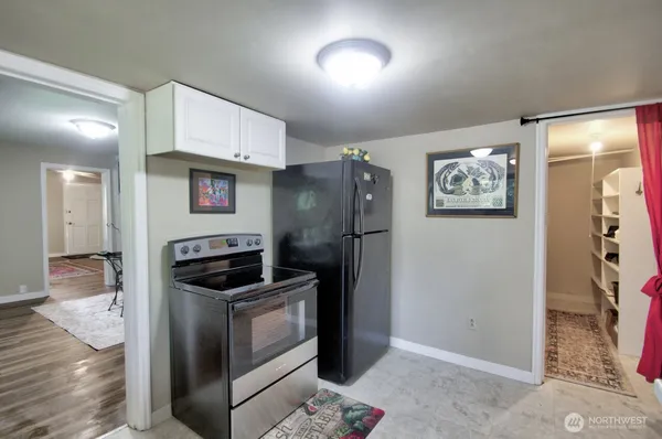 a kitchen with stainless steel appliances granite countertop a refrigerator sink and stove