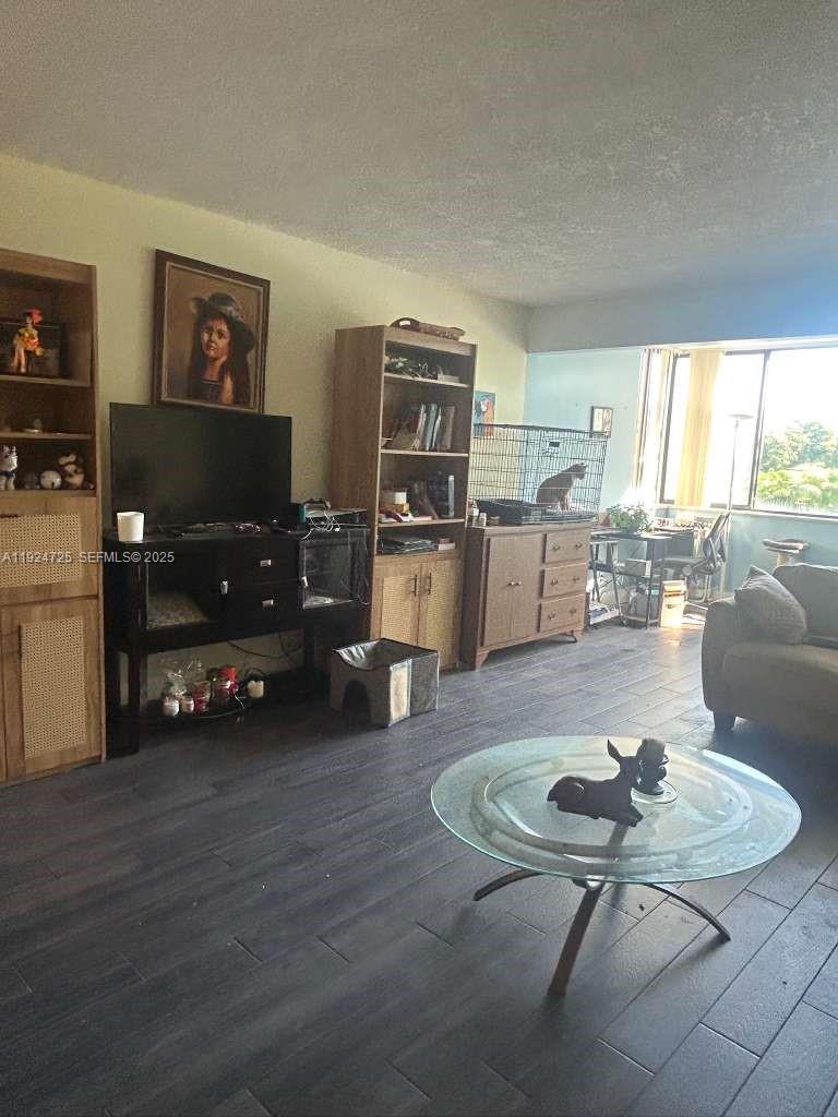 8020 Hampton Boulevard, Unit 202 North Lauderdale, FL 33068 - Photo 16 of 26 a living room with furniture and wooden floor