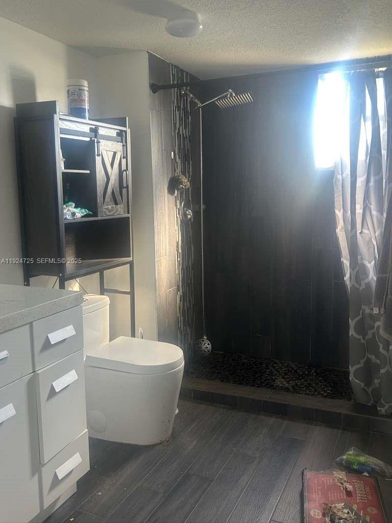 8020 Hampton Boulevard, Unit 202 North Lauderdale, FL 33068 - Photo 19 of 26 a bathroom with a toilet a sink and mirror