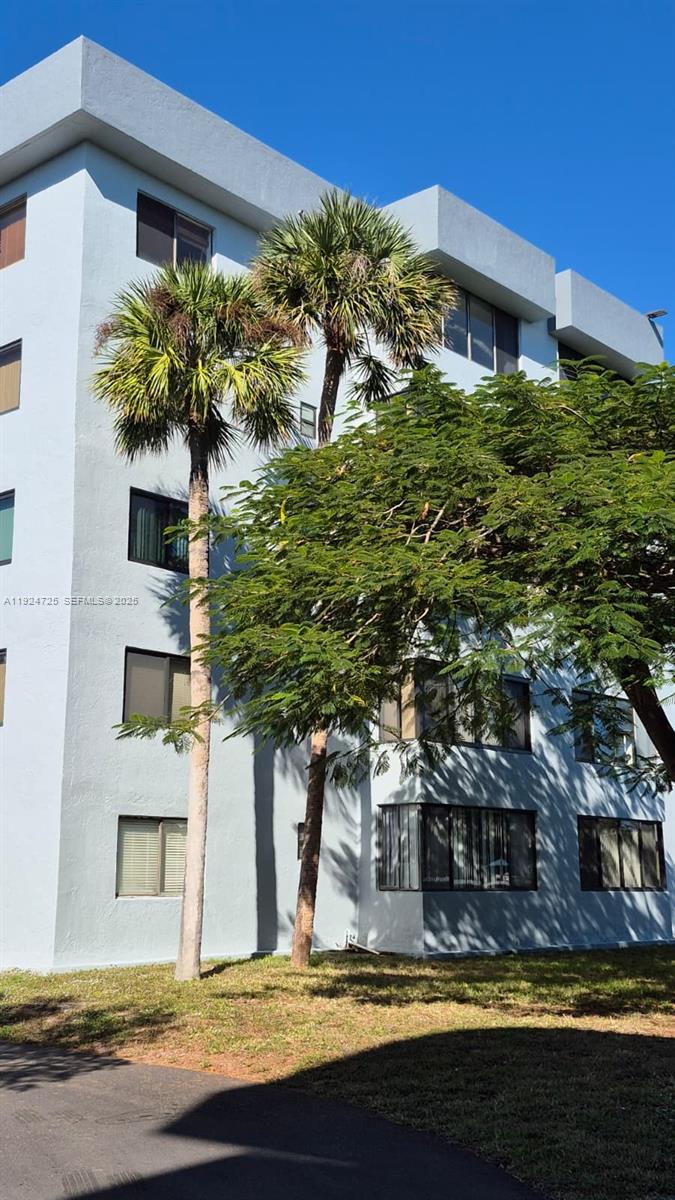 8020 Hampton Boulevard, Unit 202 North Lauderdale, FL 33068 - Photo 2 of 26 a view of a house with a yard