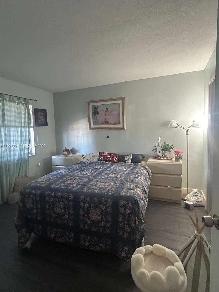 8020 Hampton Boulevard, Unit 202 North Lauderdale, FL 33068 - Photo 25 of 26 a bedroom with a bed and window
