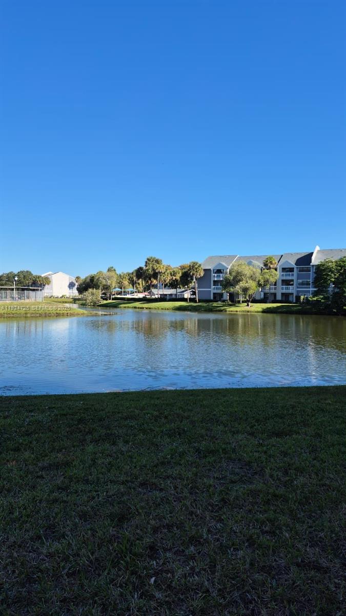 8020 Hampton Boulevard, Unit 202 North Lauderdale, FL 33068 - Photo 6 of 26 a view of a lake with houses in the back