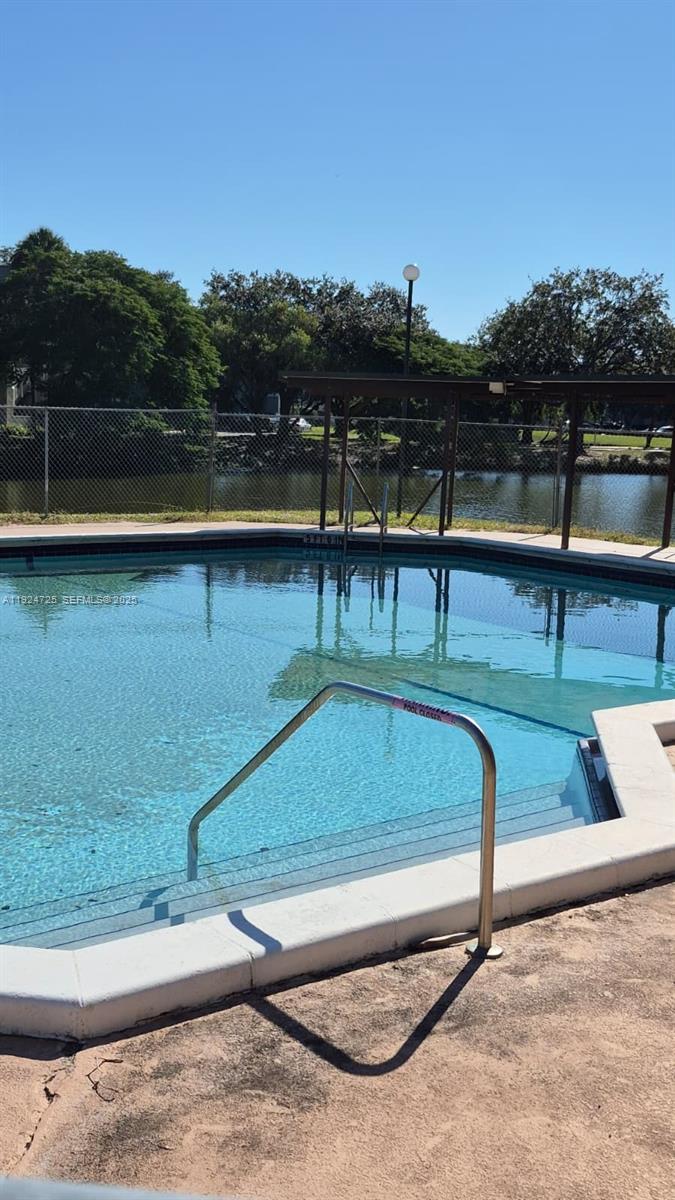 8020 Hampton Boulevard, Unit 202 North Lauderdale, FL 33068 - Photo 9 of 26 a view of a swimming pool with a yard